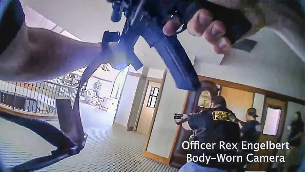 This image provided by Metropolitan Nashville Police Department shows bodycam footage of police responding to an active shooting at The Covenant School in Nashville, Tenn., on Monday, March 27, 2023. The former student who shot through the doors of the Christian elementary school and killed three children and three adults had drawn a detailed map of the school. (Metropolitan Nashville Police Department via AP)