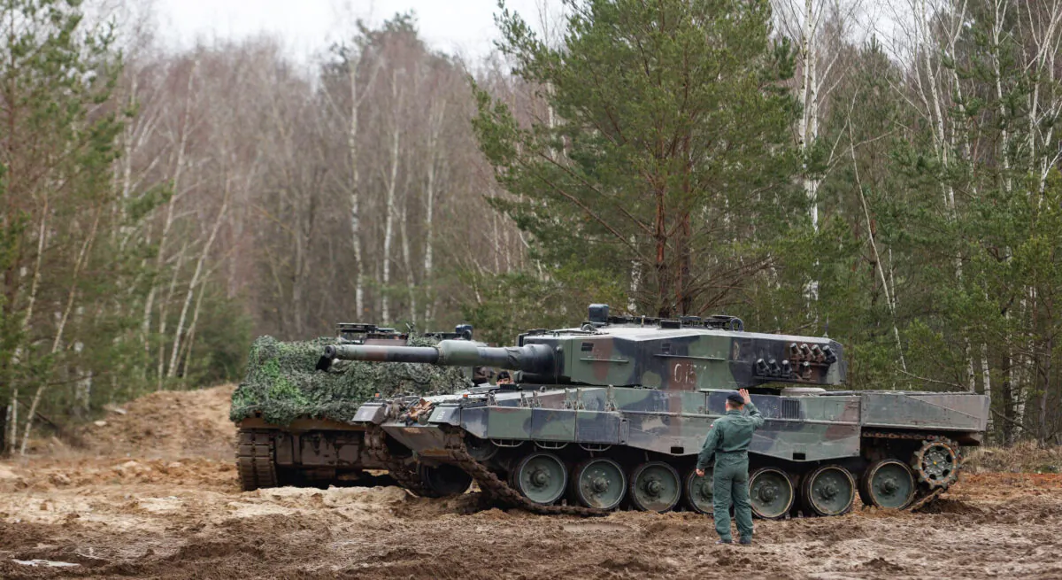 A Polish soldier navigates the Leopard 2 tank during a training at a military base and test range in Swietoszow, Poland, on Feb. 13, 2023. (Michal Dyjuk/AP Photo)