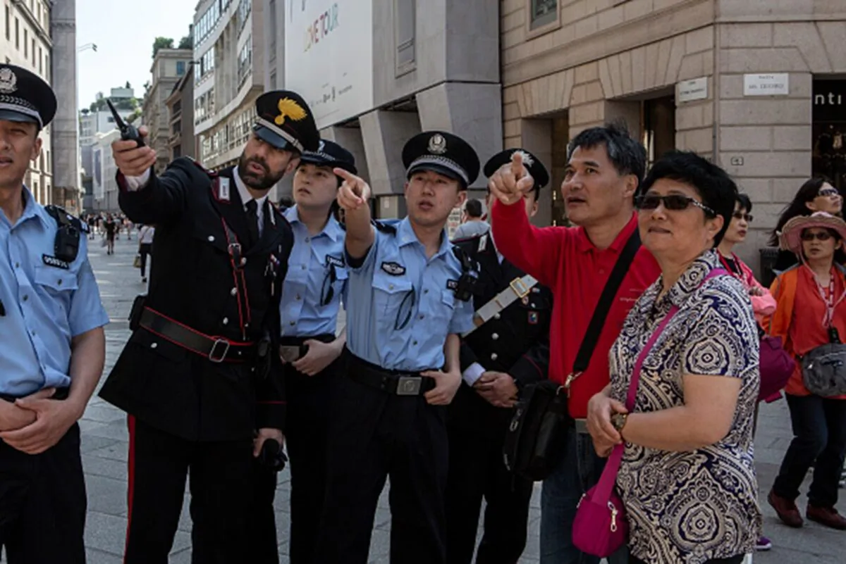 Italian Carabinieri and Chinese police on joint patrol with two Chinese tourists in the center of Milan on June 1, 2018. The joint patrols between Italian Carabinieri and Chinese police were mostly carried out in Rome, Milan, Venice, and Prato. (Emanuele Cremaschi/Getty Images)