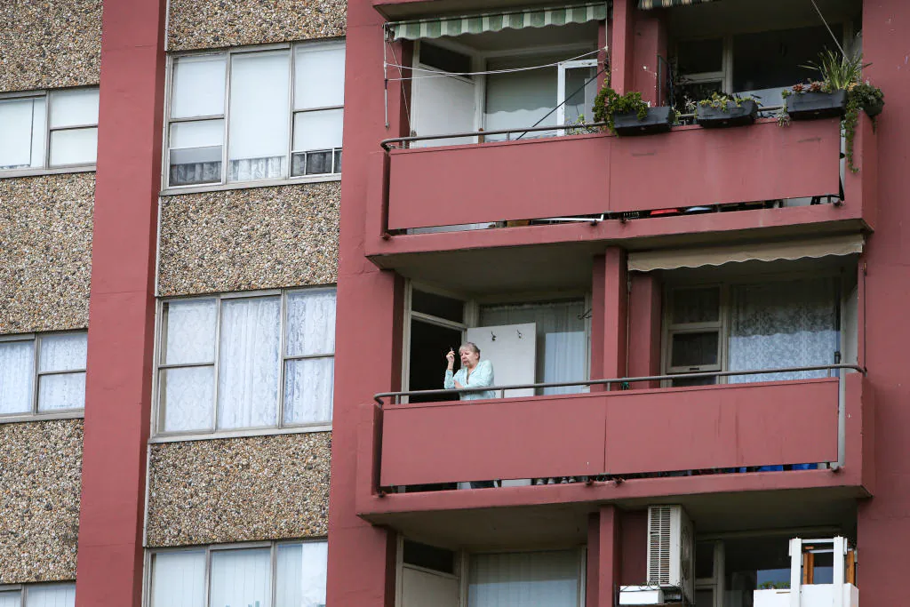 A resident stands on a balcony of a public housing apartment in Redfern in Sydney, Australia, on Sept. 16, 2021. (Lisa Maree Williams/Getty Images)
