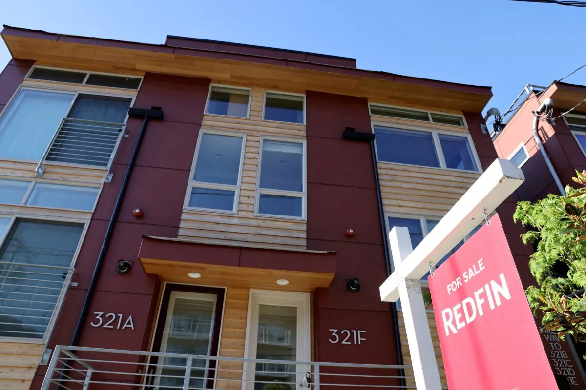 A 'For Sale' sign is posted outside a residential home in Seattle, Wash., on May 14, 2021. (Karen Ducey/Reuters)