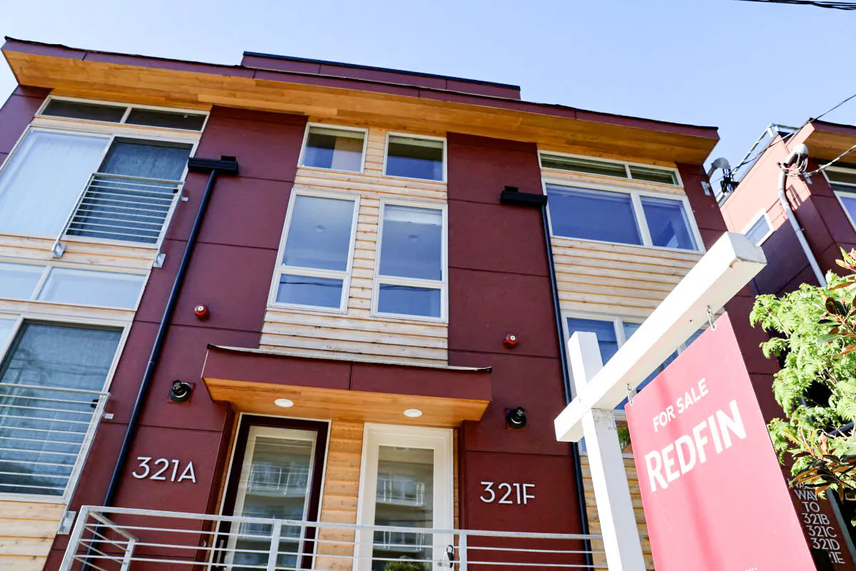 A "For Sale" sign is posted outside a residential home in the Queen Anne neighborhood of Seattle, Wash., on May 14, 2021. (Karen Ducey/Reuters)