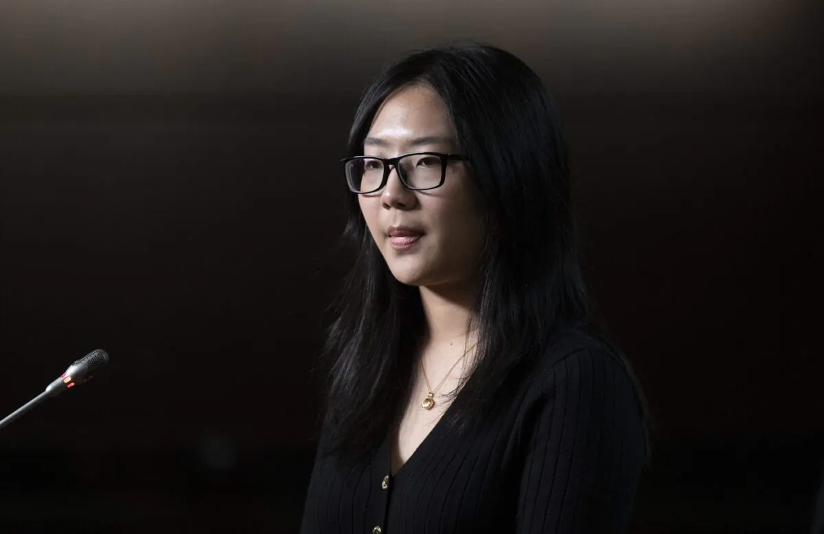 Katherine Dong listens to a question from a reporter as she takes part in a news conference for the release of her father Dong Guangping, on Parliament Hill, Nov. 17, 2022 in Ottawa. (The Canadian Press/Adrian Wyld)
