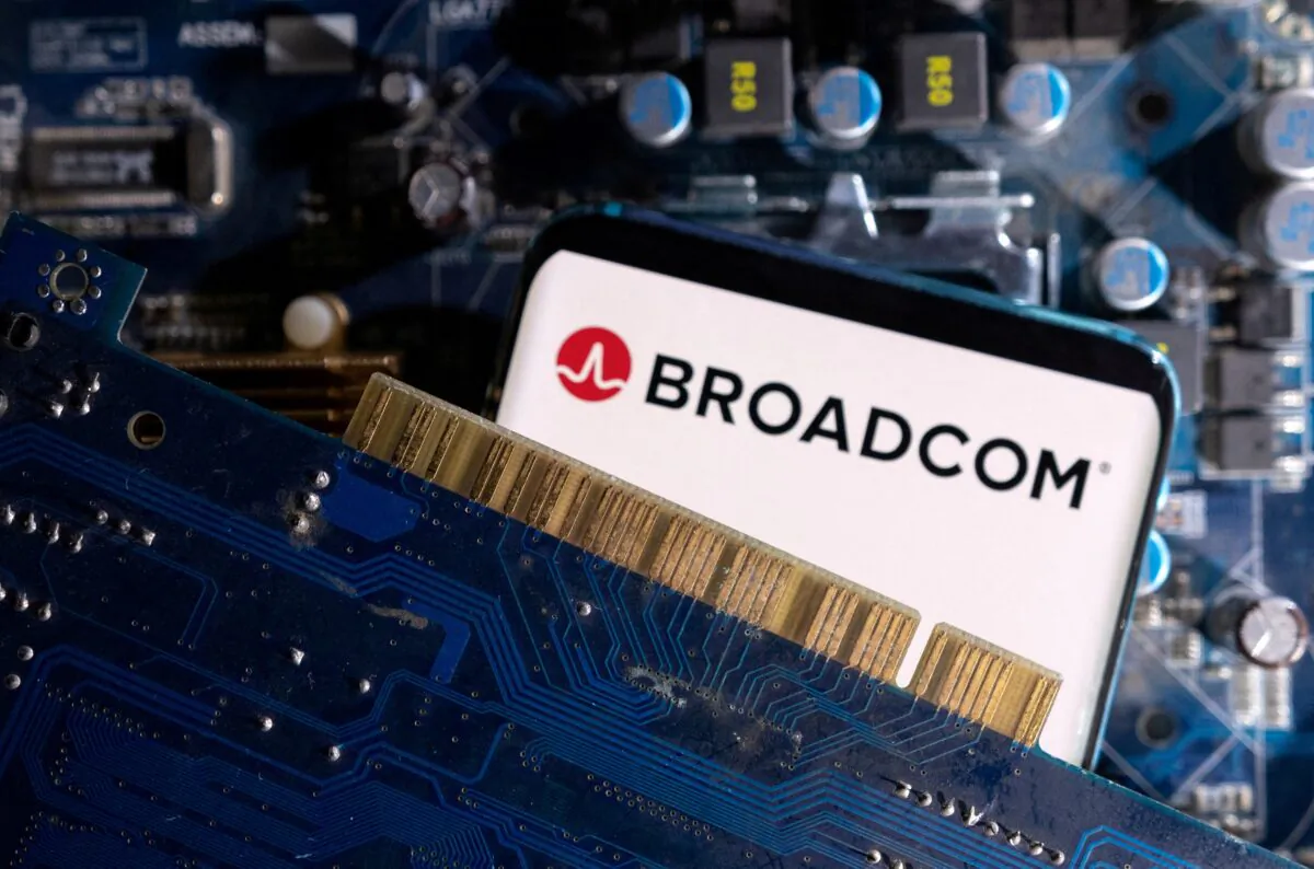 A smartphone with a displayed Broadcom logo is placed on a computer motherboard in an illustration taken on March 6, 2023. (Dado Ruvic/Illustration/Reuters)
