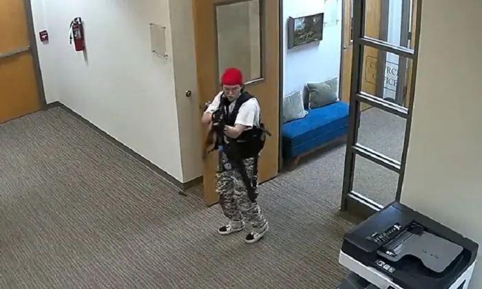 In this image from video, Audrey Hale points a gun inside the Covenant School in Nashville, Tenn., on March 27, 2023. (Nashville Police Department via The Epoch Times)