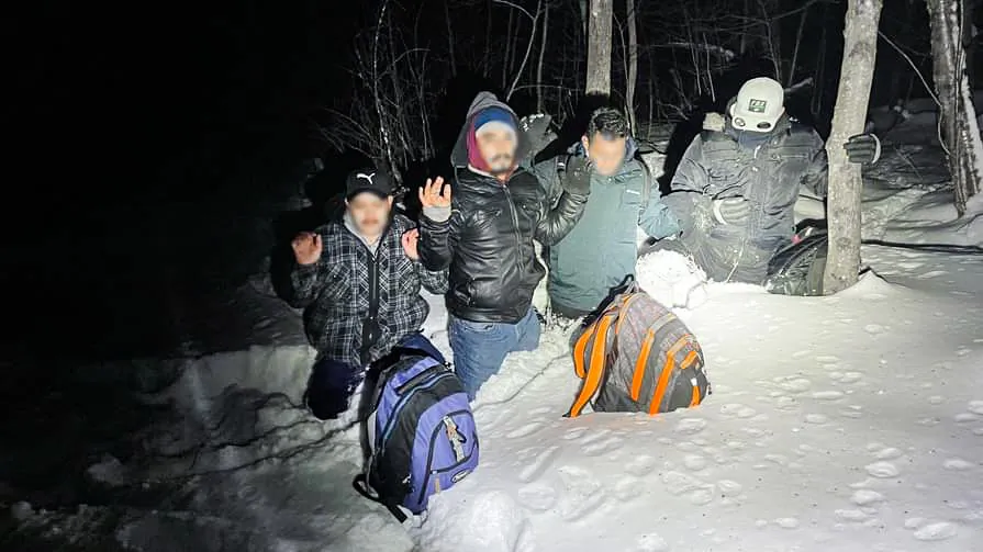 U.S. Border Patrol agents of the Swanton Sector on the U.S.-Canada border detain illegal migrants. (U.S. Border Patrol photo)