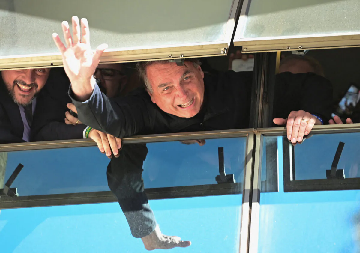 Brazil's former President Jair Bolsonaro waves at Brasilia International Airport as he returns from self imposed exile in Fla. after the defeat in last year's election in Brasilia, Brazil, on March 30, 2023. (Ton Molina/Reuters)