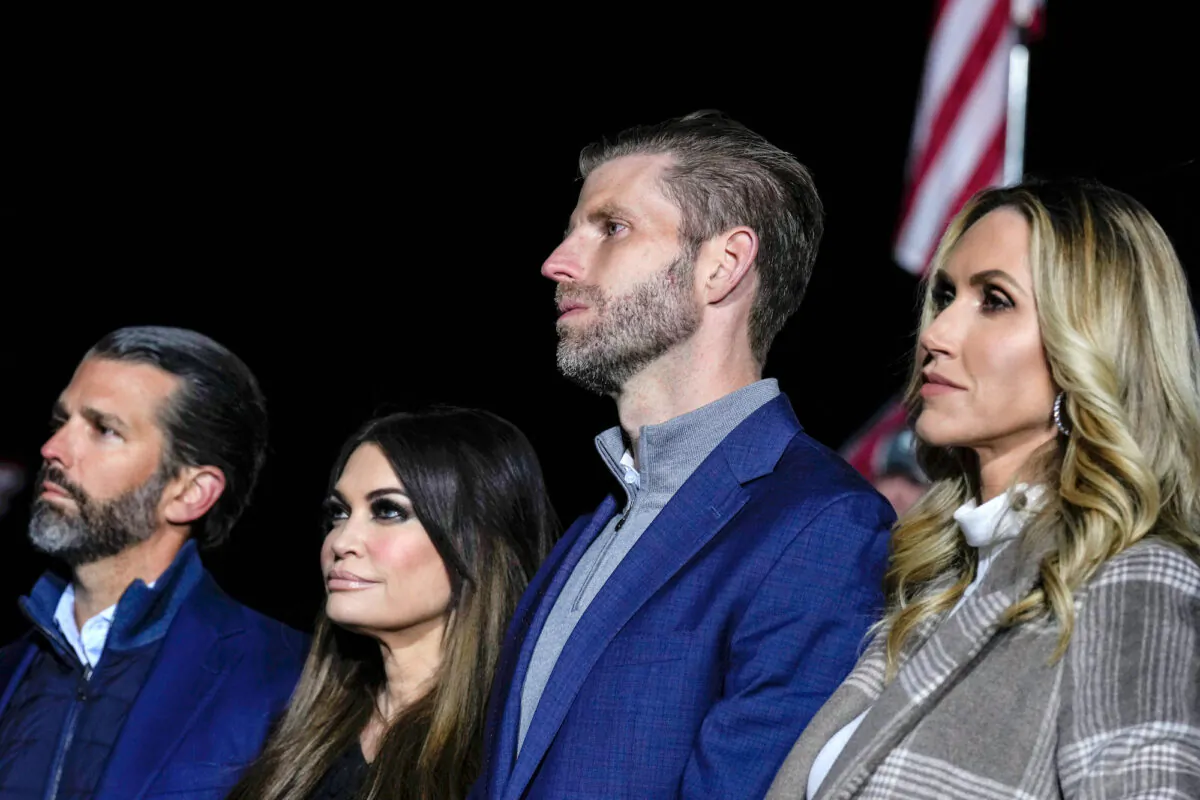 (L-R) Donald Trump Jr., Kimberly Guilfoyle, Eric Trump, and Lara Trump listen as former President Donald Trump speaks at a rally in Vandalia, Ohio, on Nov. 7, 2022. (Drew Angerer/Getty Images)