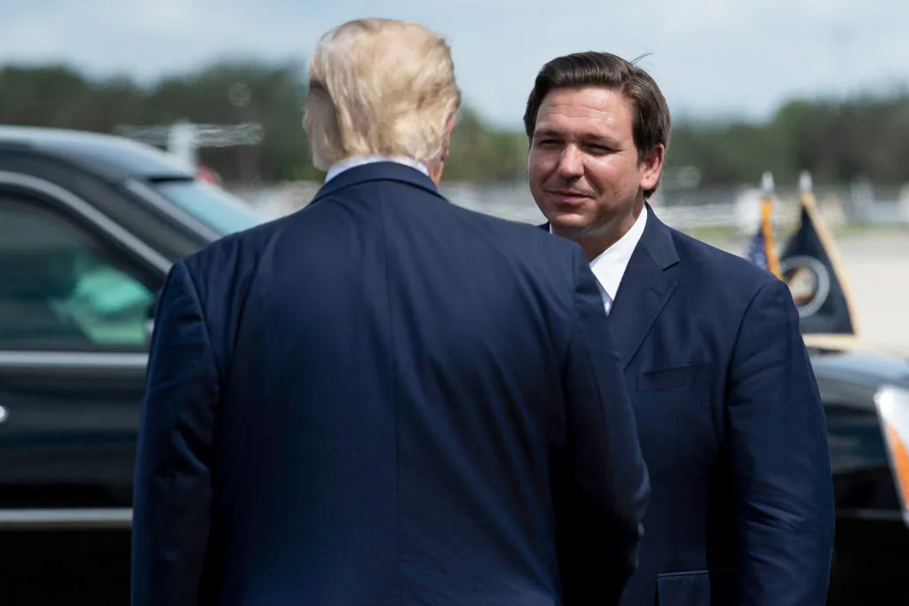President Donald Trump is greeted by Florida Gov. Ron DeSantis at Southwest Florida International Airport on Oct. 16, 2020. (Brendan  Smialowski/AFP via Getty Images)