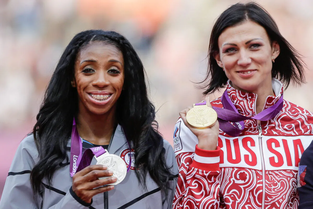 Russia's Natalya Antyukh holds the gold medal, United States' Lashinda Demus, (L), the silver medal a during a ceremony for the women's 400-meter hurdles in the Olympic Stadium at the 2012 Summer Olympics in London on Aug. 9, 2012. (Matt Slocum/AP Photo)