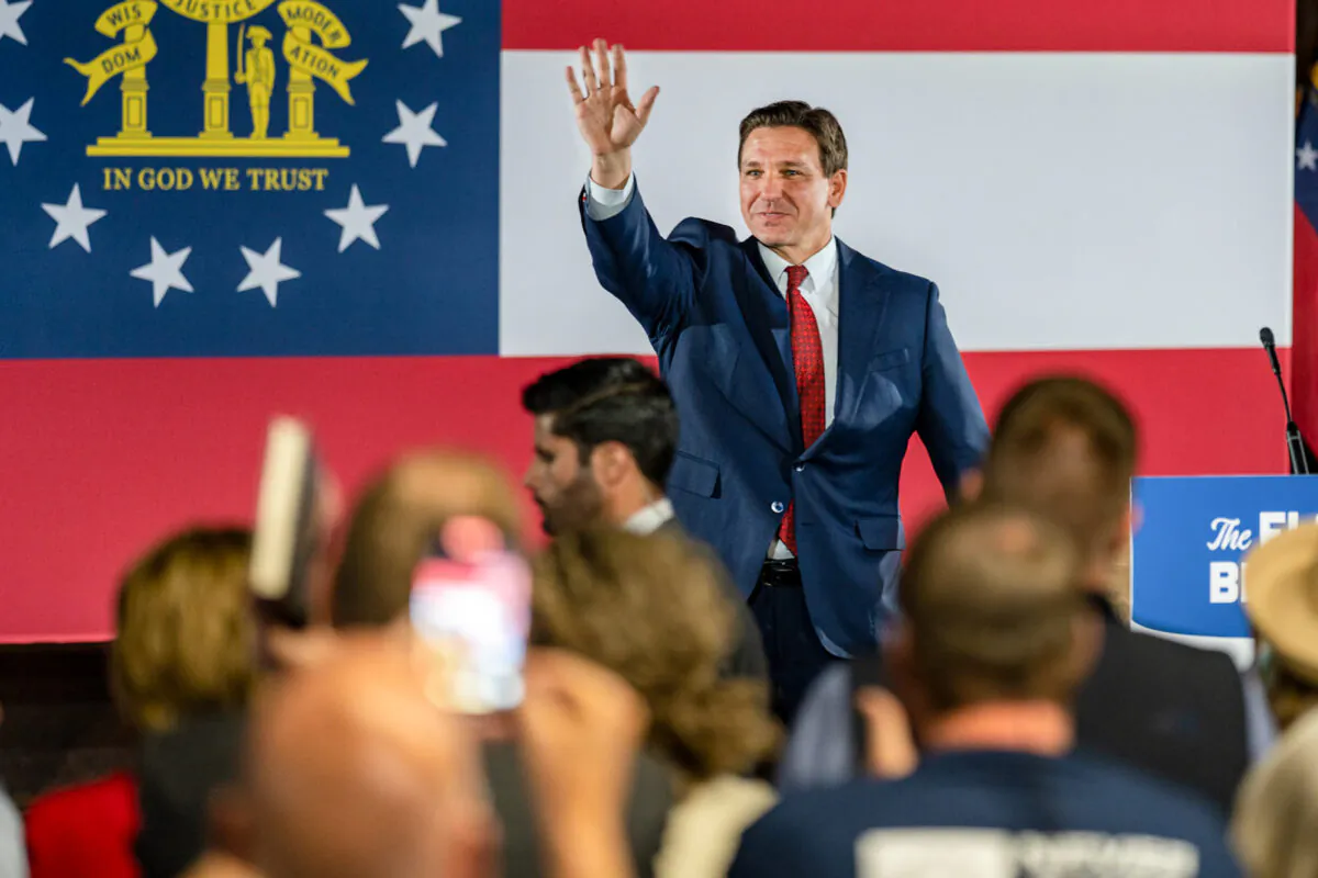 Florida Gov. Ron DeSantis greets the crowd as he begins a book tour speech at the Adventure Outdoors gun store in Smyrna, Ga. on March 30, 2023. (Phil Mistry/The Epoch Times)