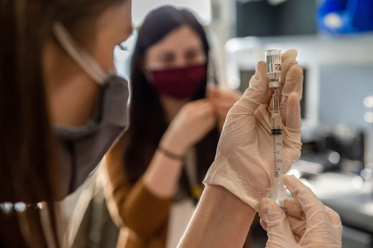 A health worker prepares COVID-19 vaccine for injection in Boston, Mass., on March 4, 2021. (Joseph Prezioso/AFP via Getty Images)