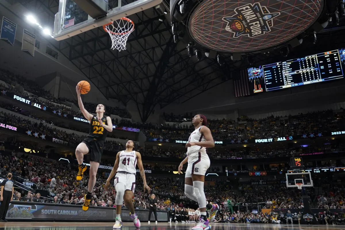 Iowa's Caitlin Clark shoots past South Carolina's Aliyah Boston and Kierra Fletcher during the first half of an NCAA Women's Final Four semifinals basketball game in Dallas on March 31, 2023. (Darron Cummings/AP Photo)