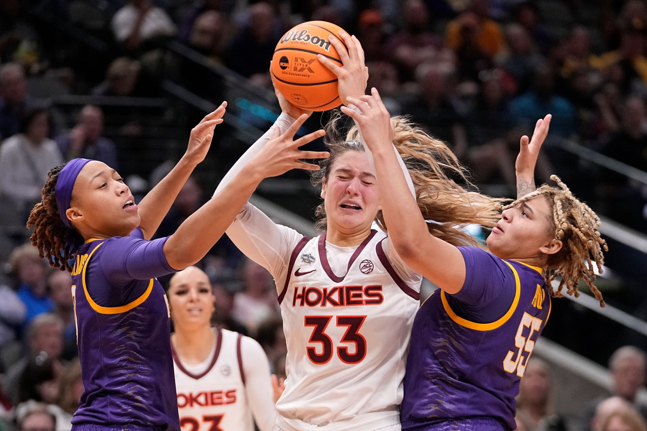 Elizabeth Kitley is trapped between LSU's LaDazhia Williams and Kateri Poole 