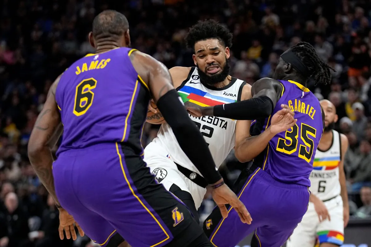 Minnesota Timberwolves center Karl-Anthony Towns works toward the basket while defended by Los Angeles Lakers forward LeBron James (6) and forward Wenyen Gabriel (35) during the first half of an NBA basketball game in Minneapolis, on March 31, 2023. (Abbie Parr/AP Photo)
