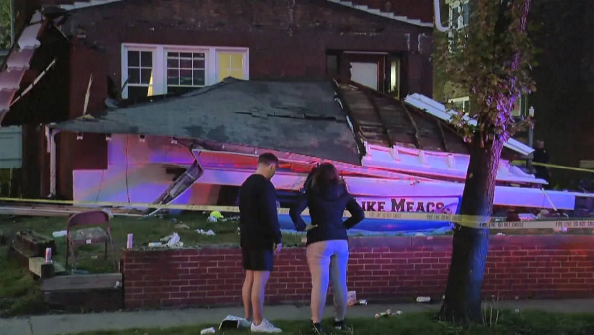 People stand in front of a house where the roof collapsed in Columbus, Ohio, on April 29, 2023. (WSYX via AP)