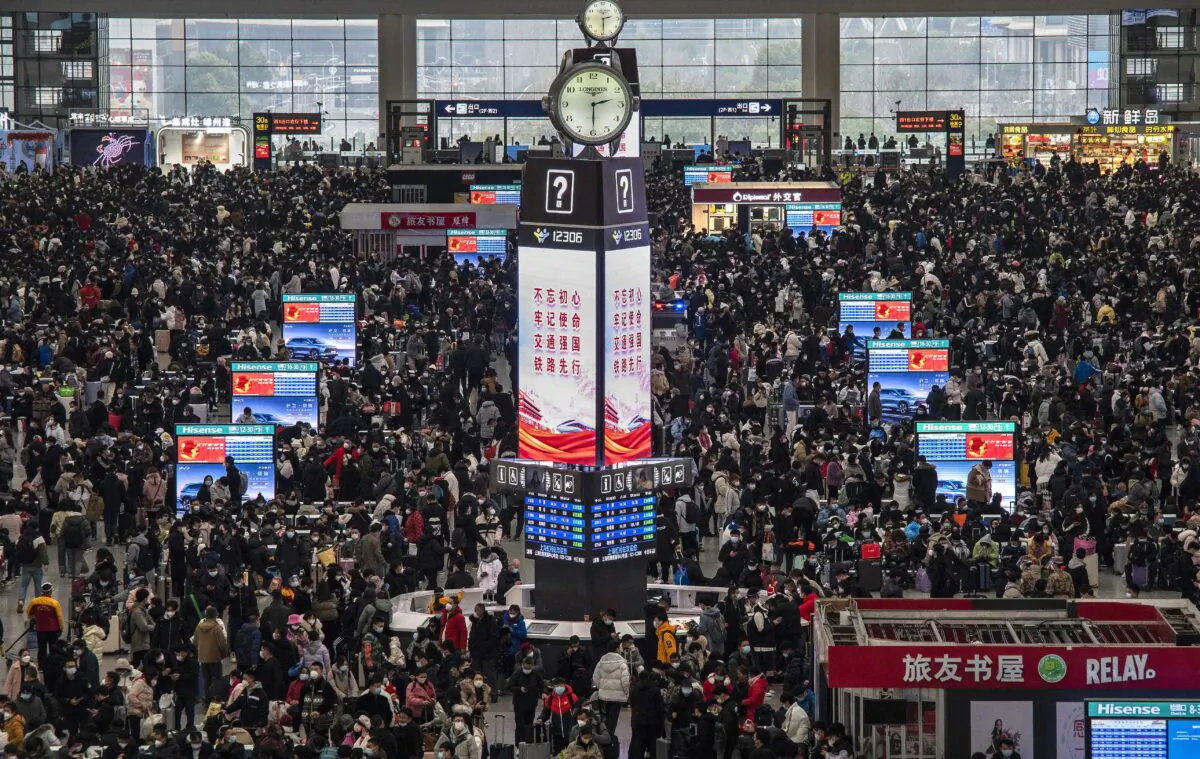 Travelers crowd at the gates and wait for trains at the Shanghai Hongqiao Railway Station during the peak travel rush for the upcoming Chinese New Year holiday in Shanghai, China, on Jan. 15, 2023. (Kevin Frayer/Getty Images)