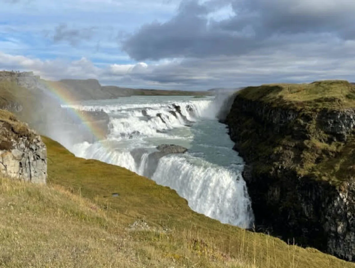 A rainbow over Iceland’s Gold Falls is said to reveal hidden treasure there. (Photo courtesy of Lesley Frederikson)