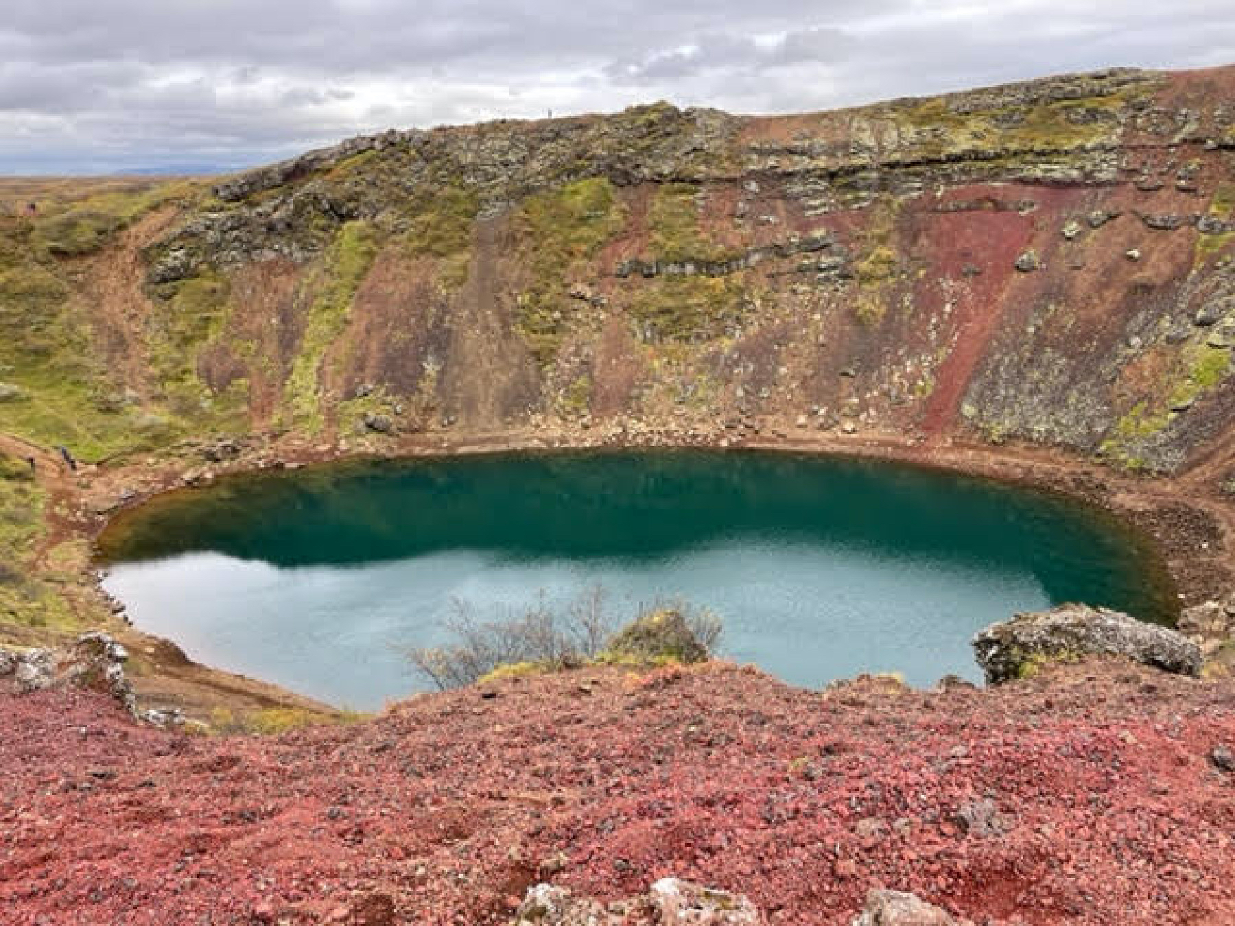 Rich rust and turquoise colors in Kerid Crater come from volcanic minerals in the soil there.