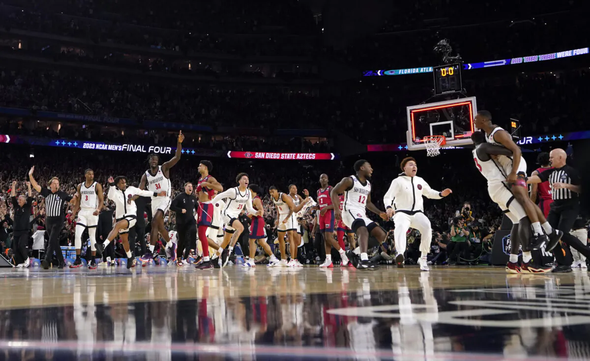 San Diego State guard Lamont Butler, right, celebrates with teammates after hitting winning shot during the second half of a Final Four college basketball game against Florida Atlantic in the NCAA Tournament in Houston on April 1, 2023. (David J. Phillip/AP Photo)