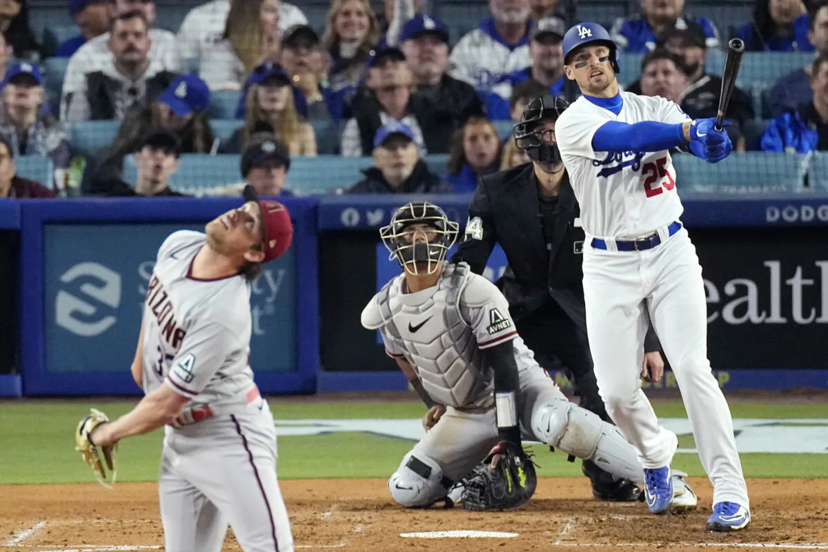 Los Angeles Dodgers' Trayce Thompson, right, hits a three-run home run as Arizona Diamondbacks relief pitcher Kevin Ginkel, left, watches along with catcher Gabriel Moreno, second from left, and home plate umpire John Tumpane during the fifth inning of a baseball game in Los Angeles on April 1, 2023. (Mark J. Terrill/AP Photo)