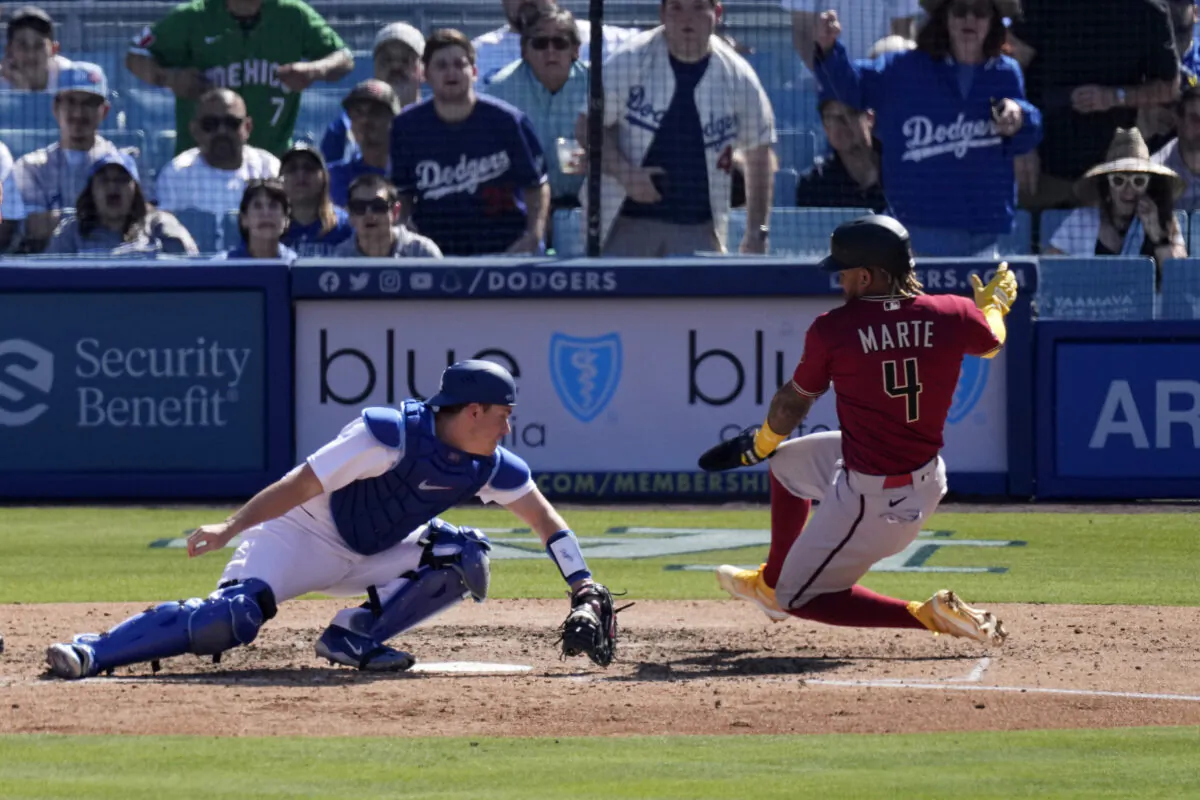 Arizona Diamondbacks' Ketel Marte, right, is tagged out by Los Angeles Dodgers catcher Will Smith while trying to score on a single by Lourdes Gurriel Jr. during the ninth inning of a baseball game in Los Angeles on April 2, 2023. (Mark J. Terrill/AP Photo)