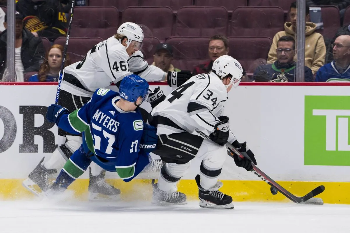 Los Angeles Kings forward Blake Lizotte (46) and forward Arthur Kaliyev (34) check Vancouver Canucks defenseman Tyler Myers (57) in the second period at Rogers Arena. (Bob Frid/USA TODAY Sports via Field Level Media)