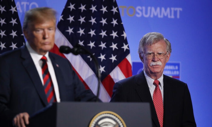 Then-President Donald Trump, flanked by then-national security adviser John Bolton, speaks to the media at a press conference. (Sean Gallup/Getty Images)