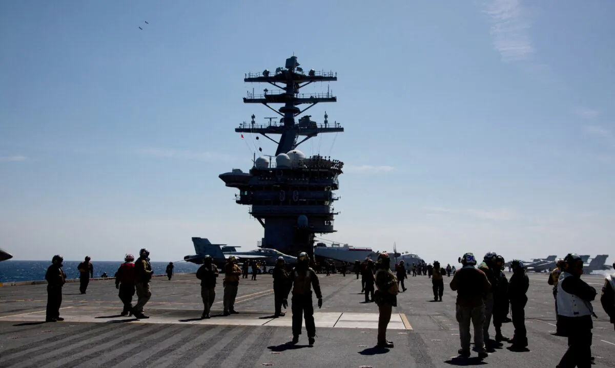 Crews on the flight deck of the USS Nimitz, off the coast of Busan, South Korea, on March 27, 2023. (Jeon Heon-Kyun/Pool via Reuters)