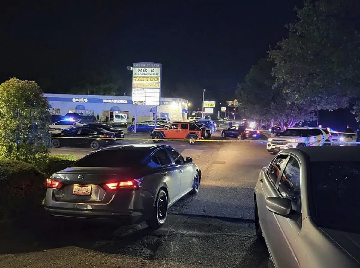 Police is working on the scene of a shooting near the V Luxx Hookah Lounge in Fayetteville, N.C., on April 3, 2023. (Fayetteville Police Department via AP)