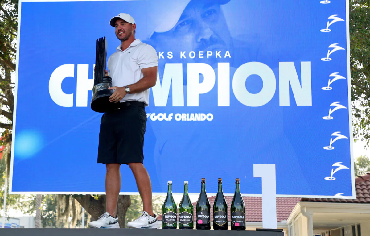 Captain Brooks Koepka of Smash GC celebrates with the trophy after winning the LIV Golf Invitational—Orlando at The Orange County National in Orlando, Fla., on April 2, 2023. (Mike Ehrmann/Getty Images)