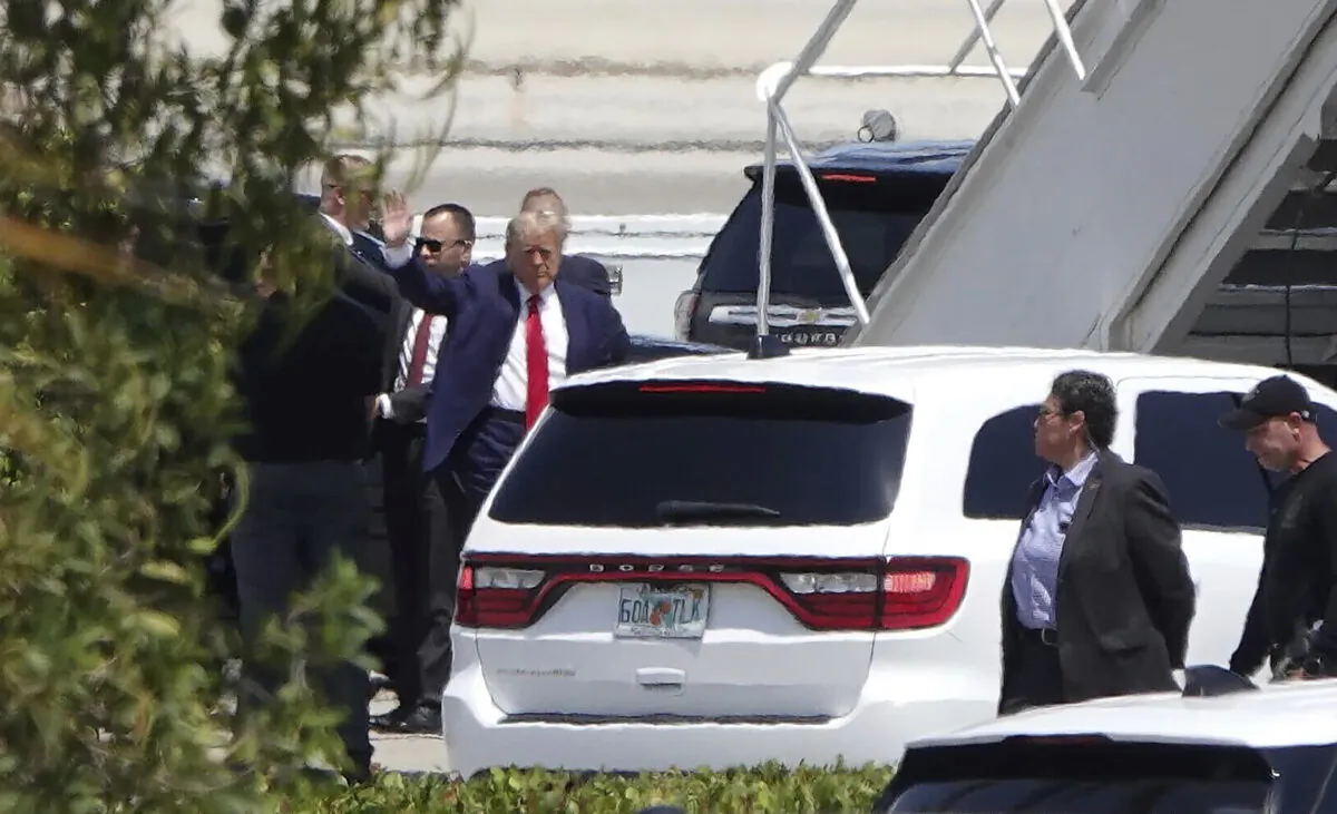 Former President Donald Trump waves before boarding his plane at Palm Beach International Airport in West Palm Beach, Fla., on April 3, 2023. (Joe Cavaretta/South Florida Sun-Sentinel via AP)