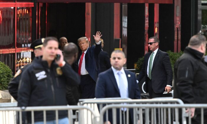 Former US President Donald Trump waves as he arrives at Trump Tower in New York on April 3, 2023.  (ED JONES/AFP via Getty Images)