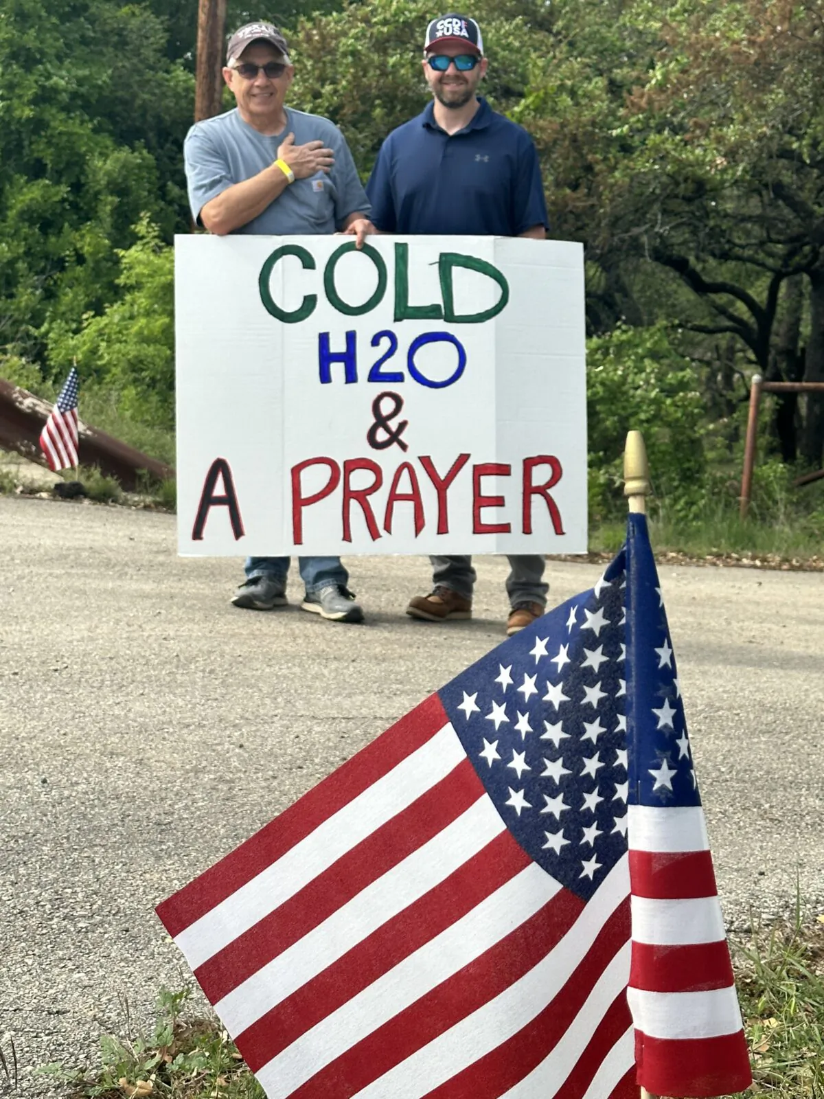 San Marcos resident Guy Hennager (Left) and Colby Wiltse, (Right) state director of the CCDF Texas,  offered those attending a dark metal festival water and a prayer. (Darlene McCormick Sanchez/ The Epoch Times)