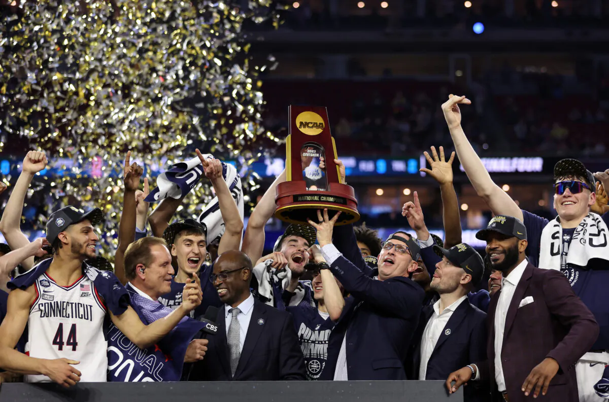 Head coach Dan Hurley of the Connecticut Huskies holds up the championship trophy after defeating the San Diego State Aztecs during the NCAA Men's Basketball Tournament National Championship game at NRG Stadium in Houston on April 3, 2023. (Gregory Shamus/Getty Images)