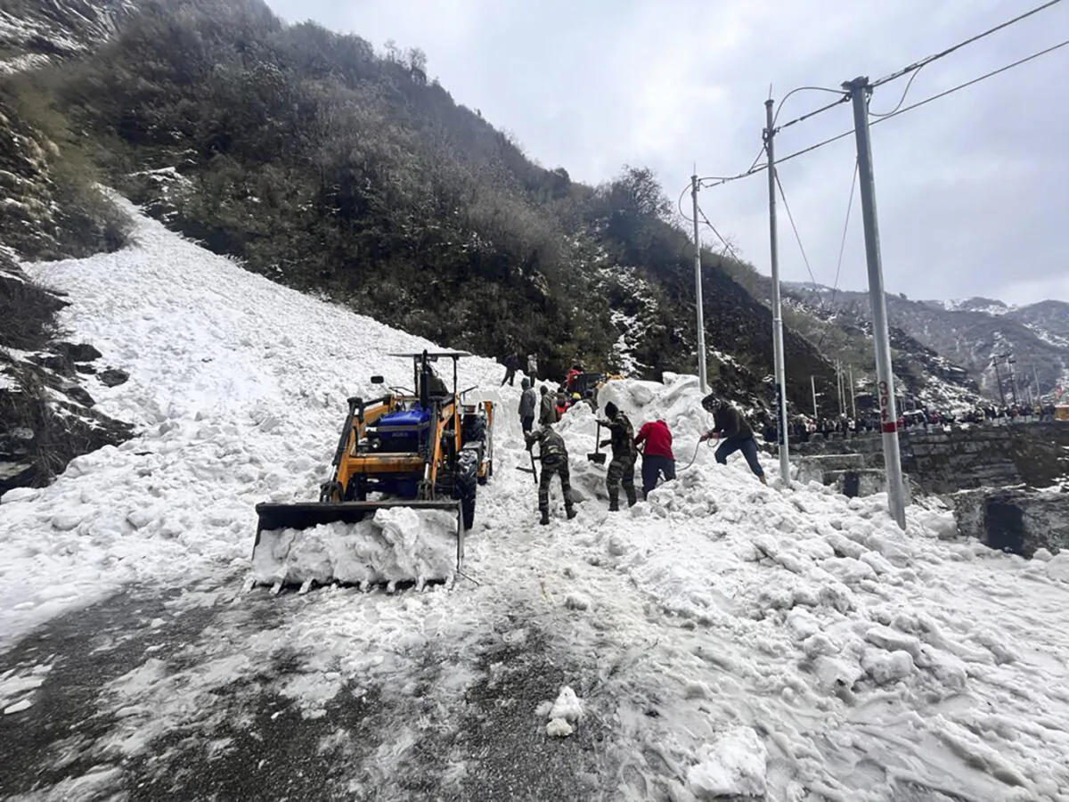 Soldiers clear snow from an avalanche near Nathu La mountain pass in India's Sikkim state on April 4, 2023. (Indian Army via AP)