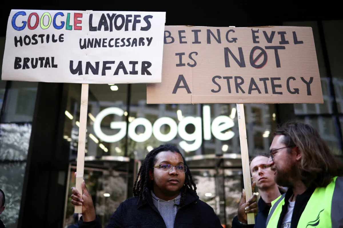 Google worker Shaquille holds a sign at a demonstration against alleged union busting and layoffs risk outside the Kings Cross headquarters in London on April 4, 2023. (Henry Nicholls/Reuters)