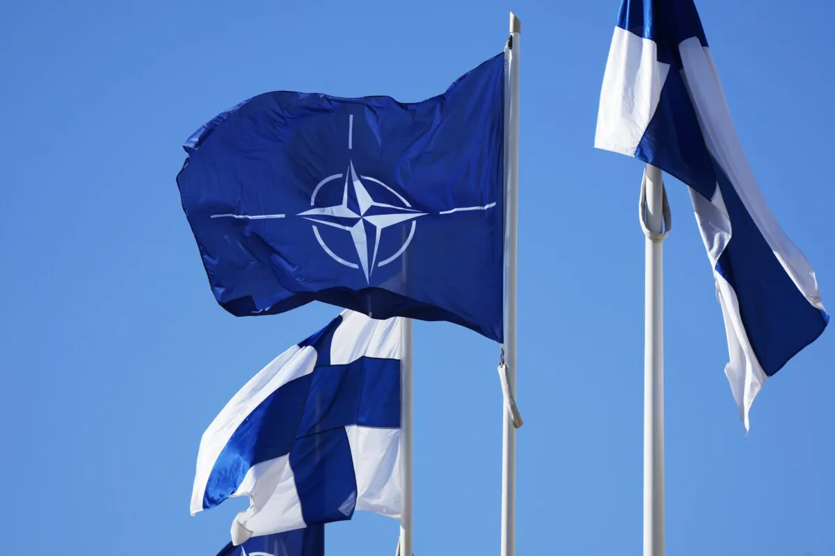 NATO flag (C) and Finland flags flutter over the building of Ministry of Foreign Affairs in Helsinki on April 4, 2023. (Sergei Grits/AP Photo)