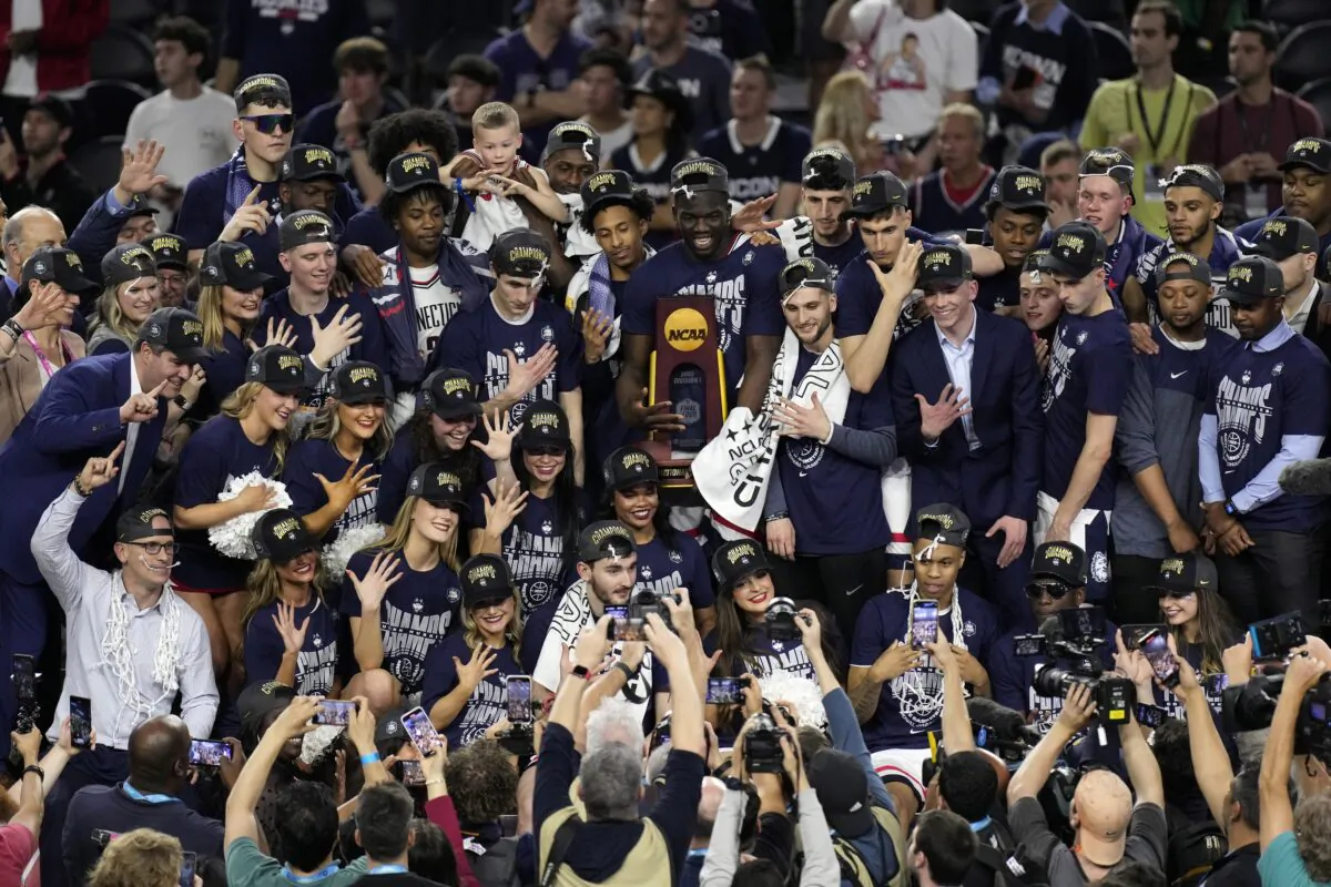Connecticut players and coaches celebrate after their win over San Diego State in the men's national championship college basketball game in the NCAA Tournament in Houston on April 3, 2023. (Godofredo A. Vasquez/AP Photo)
