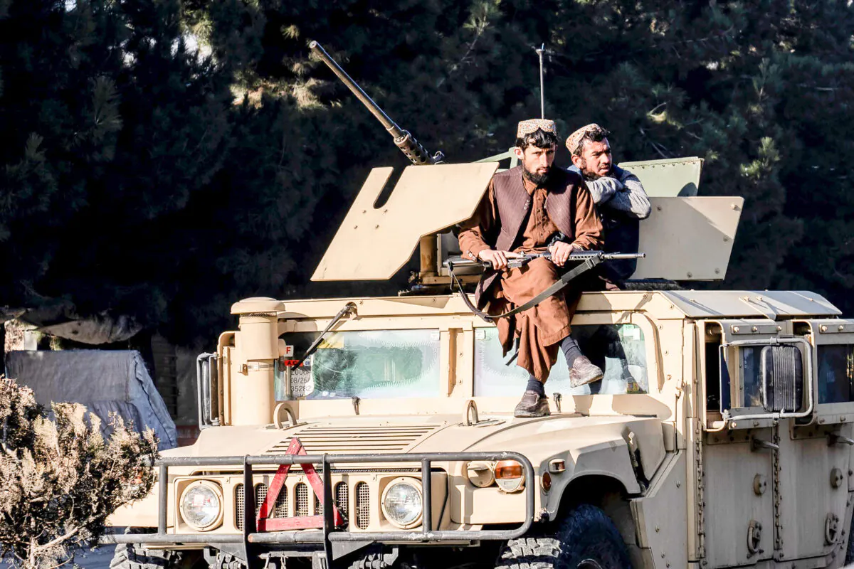 Taliban extremists stand guard at the site of an explosion, near the Interior Ministry, in Kabul, Afghanistan, on Jan. 1, 2023. (Ebrahim Noroozi/AP Photo)