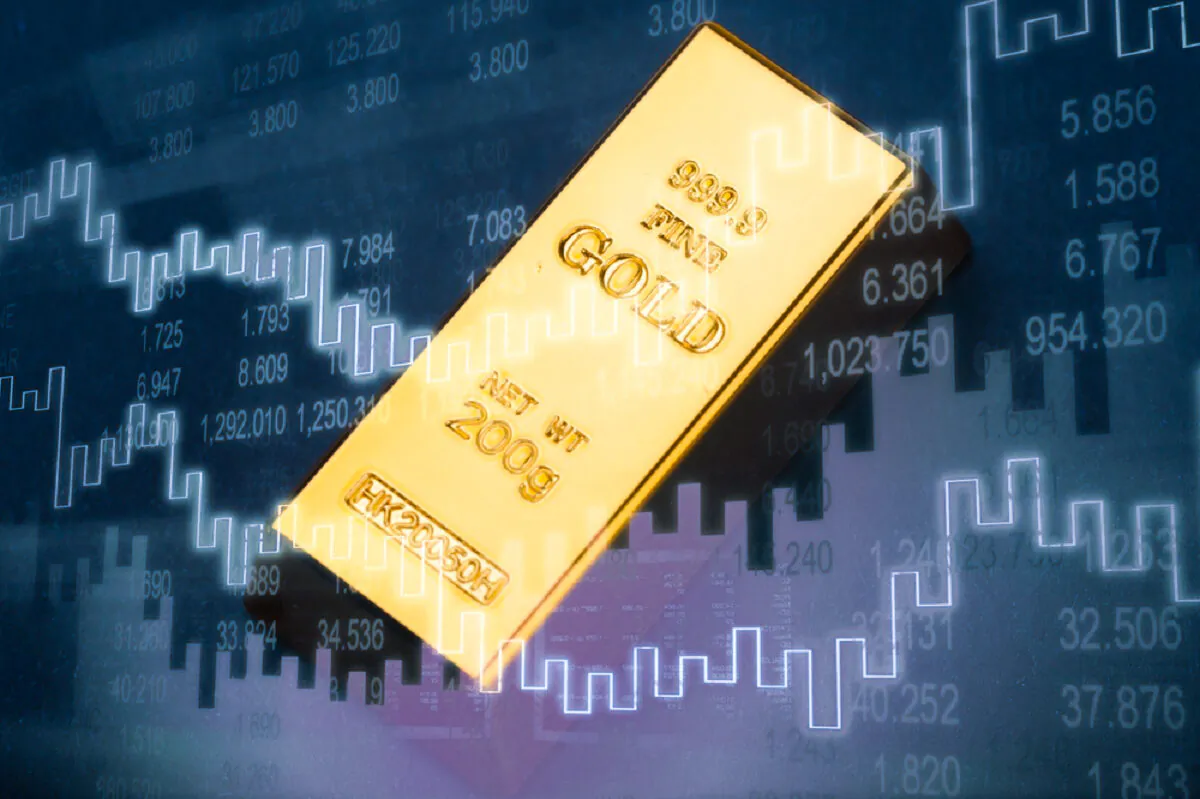 Gold bar and rising chart. (Billion Photos/Shutterstock)
