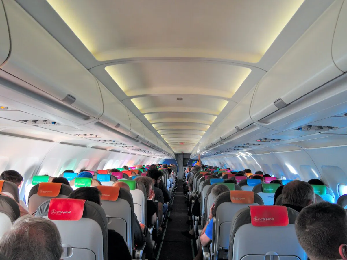 Passengers flying coach on a commercial flight. (Dreamstime)