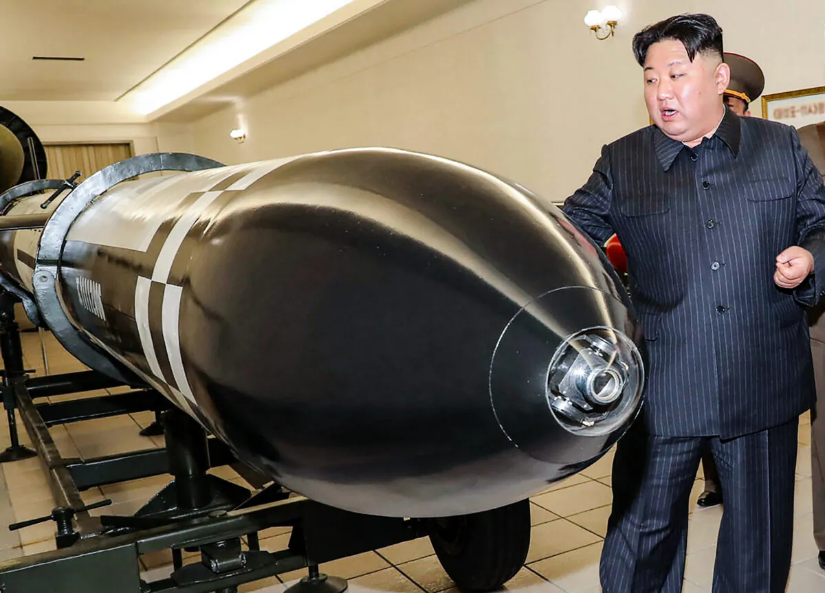 North Korean leader Kim Jong Un visits a hall displaying what appear to be various types of warheads designed to be mounted on missiles or rocket launchers in undisclosed location in North Korea on March 27, 2023. (Korean Central News Agency/Korea News Service via AP)