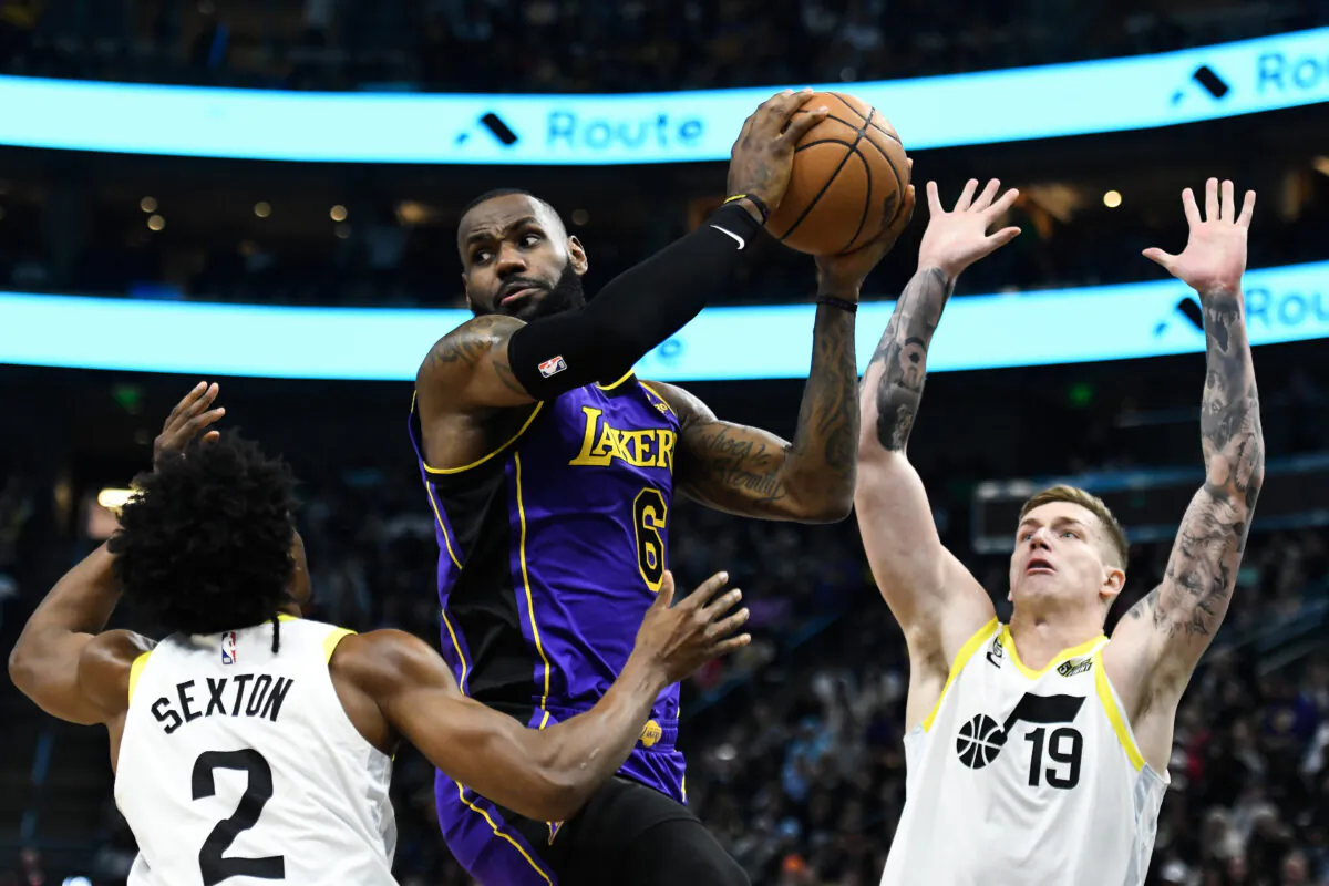 LeBron James #6 of the Los Angeles Lakers looks to pass around Collin Sexton (2) and Luka Samanic (19) of the Utah Jazz during the second half at Vivint Arena in Salt Lake City on April 4, 2023. (Alex Goodlett/Getty Images)