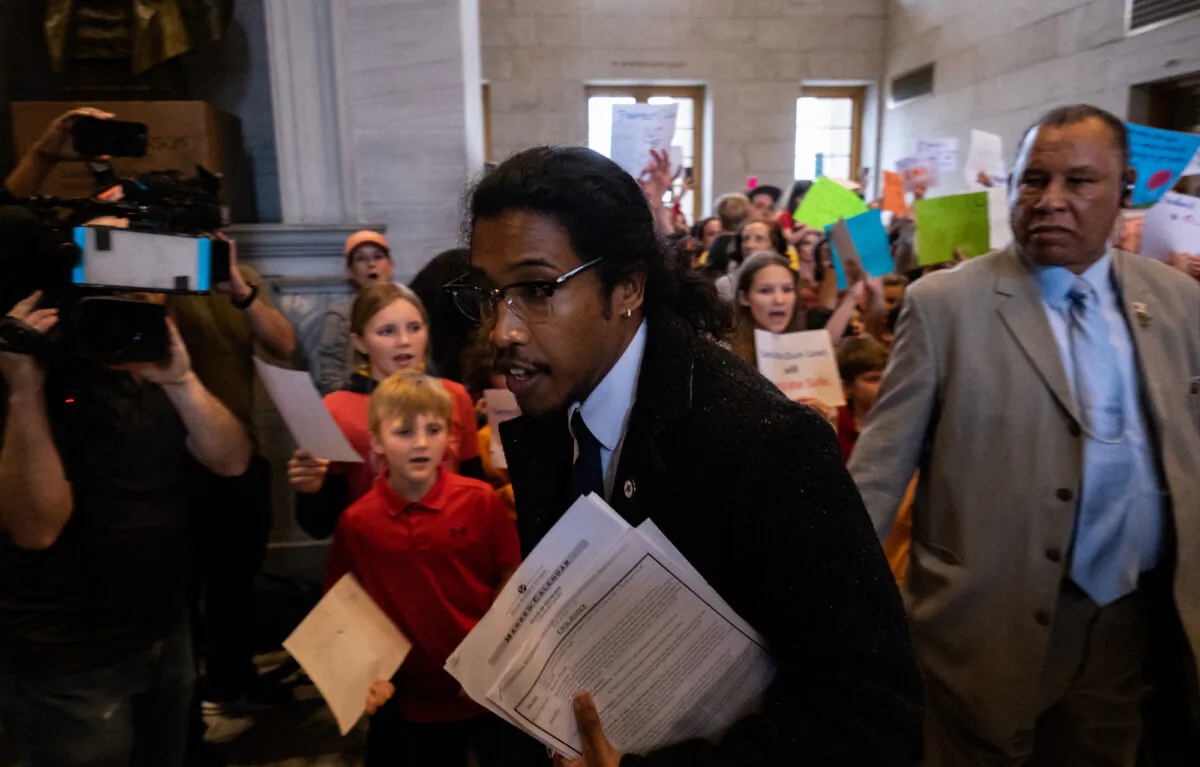 Democratic state Rep. Justin Jones enters the house chamber ahead of session as protesters chant demanding action for gun reform laws in the state at the Tennessee State Capitol in Nashville, Tenn., on April 3, 2023. (Seth Herald/Getty Images)
