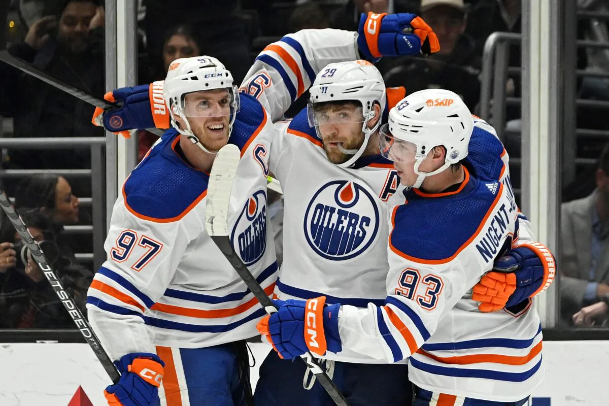 Edmonton Oilers center Leon Draisaitl (C), celebrates his goal with center Connor McDavid (L), and center Ryan Nugent-Hopkins during the second period of an NHL hockey game, in Los Angeles on April 4, 2023. (Mark J. Terrill/AP Photo)