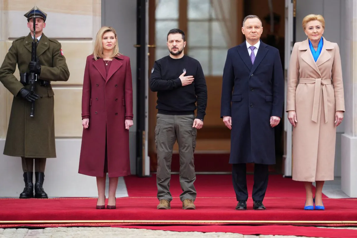 Polish President Andrzej Duda (2nd R) and his wife Agata Kornhauser-Duda (R) together with Ukrainian President Volodymyr Zelenskyy and his wife Olena Zelenska stand during an official welcoming ceremony in front of the Presidential Palace in Warsaw, Poland, on April 5, 2023.  (Aleksandra Szmigiel/Reuters)