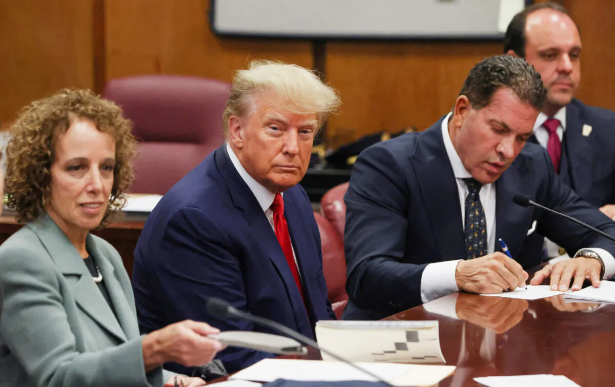 Former U.S. President Donald Trump is accompanied by members of his legal team, Susan Necheles and Joe Tacopina, as he appears in court for an arraignment on charges stemming from his indictment by a Manhattan grand jury, in New York City on April 4, 2023. (Andrew Kelly/Reuters)