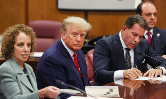 Former U.S. President Donald Trump is accompanied by members of his legal team, Susan Necheles and Joe Tacopina, as he appears in court for an arraignment on charges stemming from his indictment by a Manhattan grand jury, in New York City on April 4, 2023. (Andrew Kelly/Reuters)