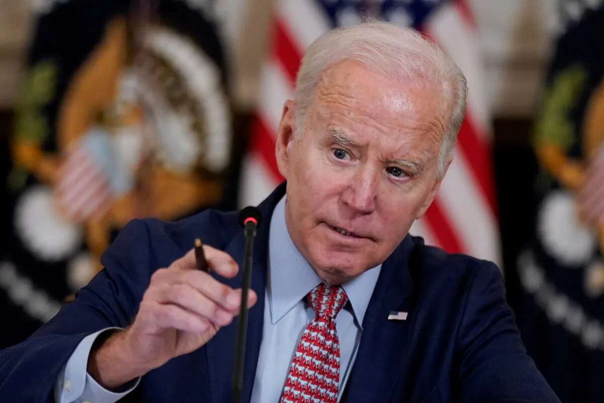 President Joe Biden adjusts his microphone during a meeting with the President's Council of Advisors on Science and Technology in the State Dining Room of the White House, in Washington on April 4, 2023. (Patrick Semansky/AP Photo)